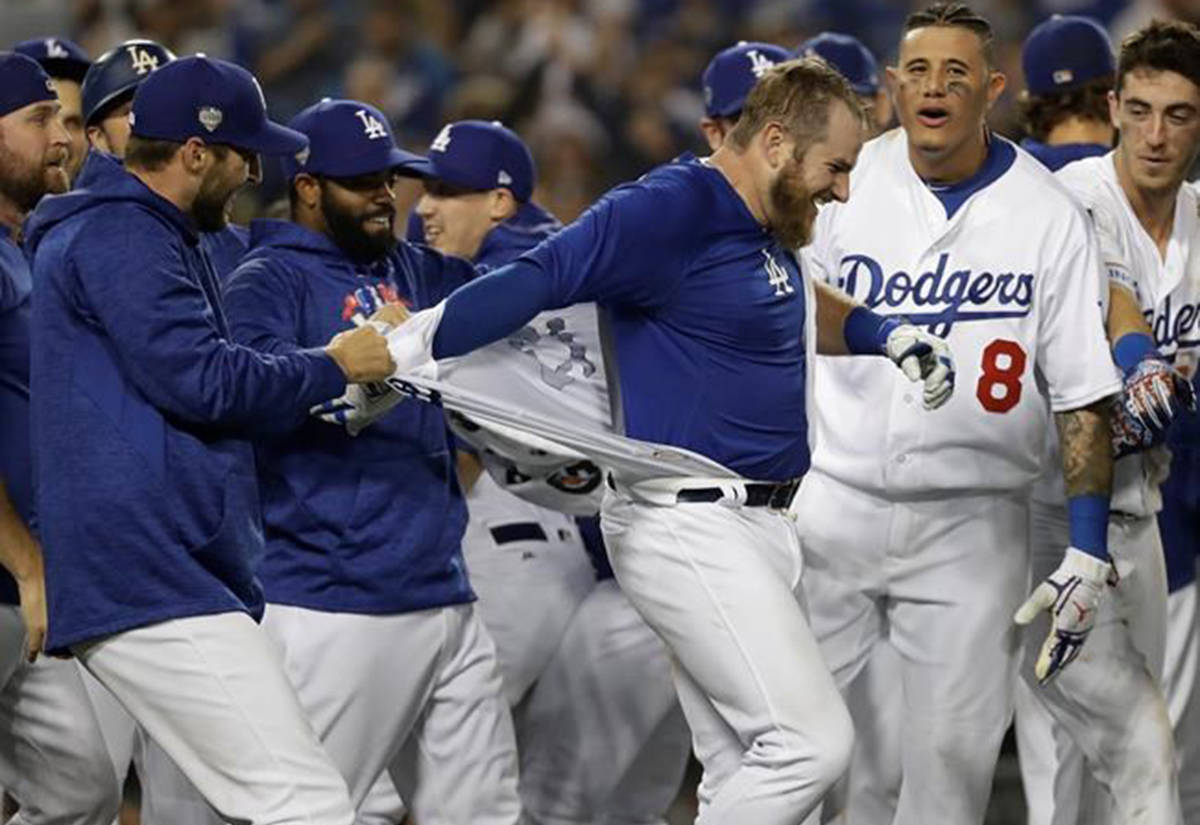 Los Angeles Dodgers tear off Max Muncy’s jersey after his walk off home run during the 18th inning in Game 3 of the World Series baseball game to defeat the Boston Red Sox 3-2 on Saturday, Oct. 27, 2018, in Los Angeles. (AP Photo/David J. Phillip)