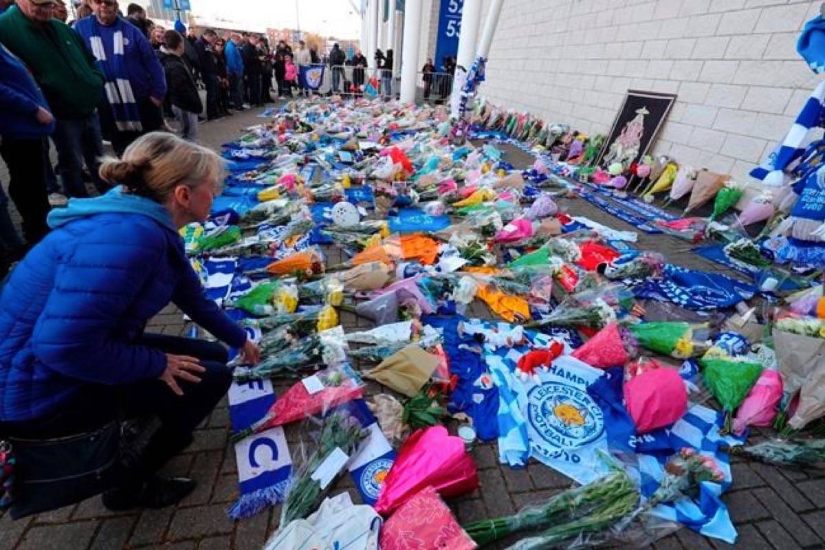 Flowers are placed outside Leicester City Football Club after a helicopter crashed in flames the previous day, in Leicester, England, Sunday, Oct. 28, 2018. A helicopter belonging to Leicester City’s owner ‚Äî Thai billionaire Vichai Srivaddhanaprabha ‚Äî crashed in flames in a car park next to the soccer club’s stadium shortly after it took off from the field following a Premier League game on Saturday night. (Aaron Chown/PA via AP)
