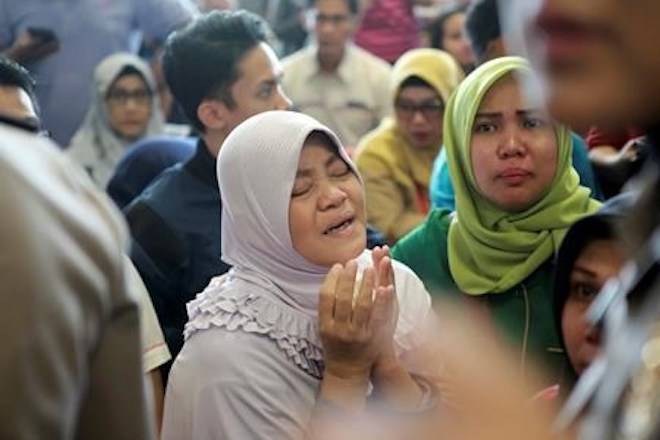 A relative of passengers prays as she and others wait for news on a Lion Air plane that crashed off Java Island at Depati Amir Airport in Pangkal Pinang, Indonesia Monday, Oct. 29, 2018. Indonesia disaster agency says that the Lion Air Boeing 737-800 plane crashed into sea shortly after it left Indonesia’s capital Monday morning. (AP Photo/Hadi Sutrisno)