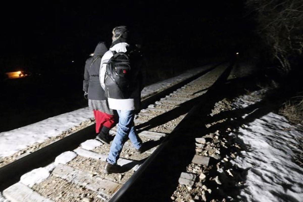 Early Sunday morning, February 26, 2017, migrants from Somalia cross into Canada illegally from the United States by walking down this train track into the town of Emerson, Man., where they will seek asylum at Canada Border Services Agency. The Canada Border Services Agency has been asked to “pick up the pace” in removing asylum seekers whose refugee claims have been rejected. (John Woods/The Canadian Press)