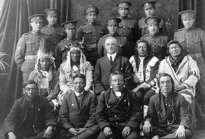 Recruits from File Hills, Saskatchewan pose with elders and a government representative in a 1915 photo from the Saskatchewan Provincial Archives Collection. THE CANADIAN PRESS/HO-Saskatchewan Provincial Archives Collection