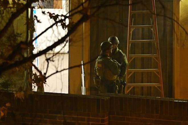 Police officers stand near the scene Thursday, Nov. 8, 2018, in Thousand Oaks, Calif. where a gunman opened fire Wednesday inside a country dance bar crowded with hundreds of people on “college night”. Ventura County sheriff’s spokesman says gunman is dead inside the bar. (AP Photo/Mark J. Terrill)