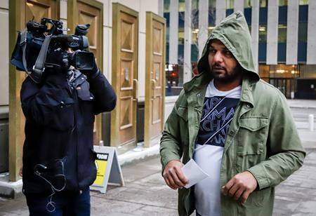 Sukhmander Singh, right, owner of the trucking company involved in the Humboldt Broncos bus crash, arrives at court to face non-compliance charges under federal and provincial safety regulations in Calgary, Alta., Friday, Nov. 9, 2018. (THE CANADIAN PRESS/Jeff McIntosh)