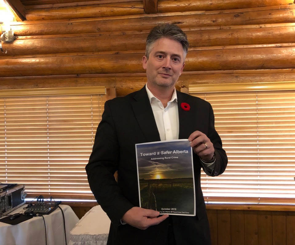 Red Deer-Lacombe MP Blaine Calkins holds up Toward a Safer Alberta: Addressing Rural Crime, which contains the results of the research conducted by the rural crime task force composed of MPs in rural ridings in Alberta. Robin Grant/Red Deer Express