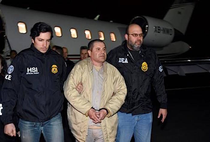 FILE - In this Jan. 19, 2017 file photo provided U.S. law enforcement, authorities escort Joaquin “El Chapo” Guzman, center, from a plane to a waiting caravan of SUVs at Long Island MacArthur Airport, in Ronkonkoma, N.Y. (U.S. law enforcement via AP, File)