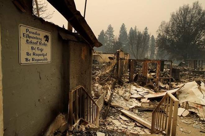 A sign hangs on a wall at the Paradise Elementary School destroyed by the Camp Fire, Tuesday, Nov. 13, 2018, in Paradise, Calif. (AP Photo/John Locher)