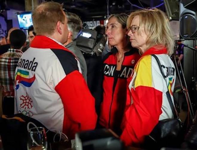 Dave King, left, Linda King, right, son and daughter of Frank King, wearing 1988 Calgary Olympic jackets react to the results of a plebiscite on whether the city should proceed with a bid for the 2026 Winter Olympics, in Calgary, Alta., Tuesday, Nov. 13, 2018.THE CANADIAN PRESS/Jeff McIntosh