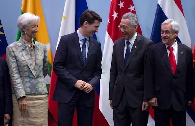 IMF Managing Director Christine Lagard, Chilean President Sebastian Pinera (right) and Singapore Prime Minister Lee Hsien Loong share a laugh with Canadian Prime Minister Justin Trudeau as they participate in a family photo before the ASEAN working luncheon in Singapore on Wednesday November 14, 2018. THE CANADIAN PRESS/Adrian Wyld