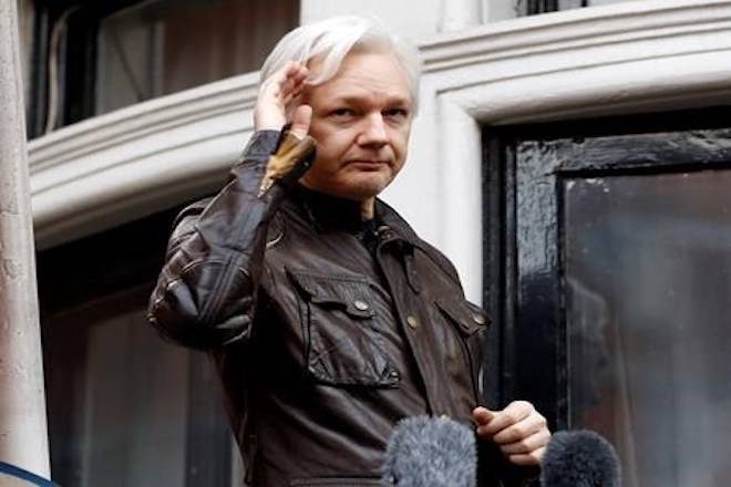 FILE - In this May 19, 2017, file photo, WikiLeaks founder Julian Assange greets supporters from a balcony of the Ecuadorian embassy in London. The Justice Department inadvertently named Assange in a court filing in an unrelated case that raised immediate questions about whether the WikiLeaks founder had been charged under seal. Assange‚Äôs name appears twice in an August 2018 filing from a prosecutor in Virginia in a separate case involving a man accused of coercing a minor. (AP Photo/Frank Augstein, File)