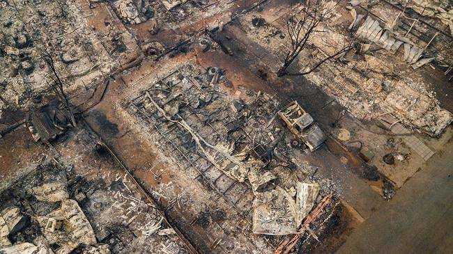 Debris and residences leveled by the wildfire line a neighborhood in Paradise, Calif., on Thursday, Nov. 15, 2018. (AP Photo/Noah Berger)