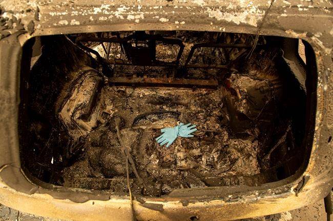 Gloves rest in a scorched car after the Camp Fire burned through Paradise, Calif., on Thursday, Nov. 15, 2018. (AP Photo/Noah Berger)