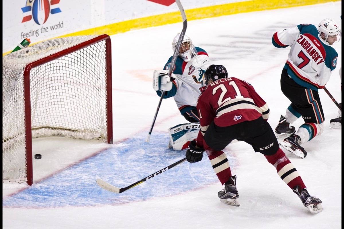 Forward Dallon Melin scores the Rebel’s second goal on Friday night with assists from Chris Douglas and Oleg Zaytsev. Red Deer sailed to victory 7-0 against the Kelowna Rockets in the first home game in over two weeks. Robin Grant/Red Deer Express