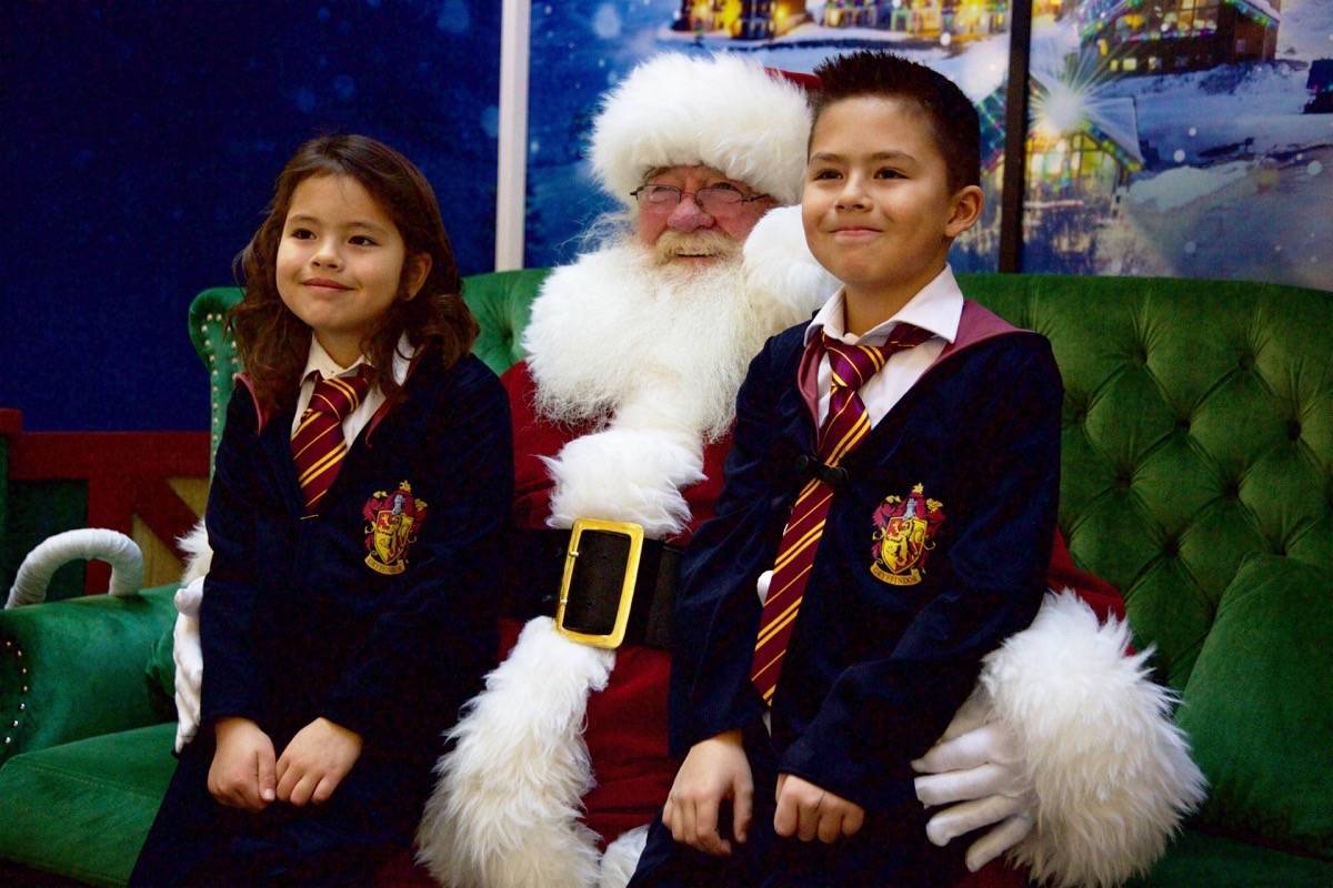 From left, Shae and Dax Klassen have their photo taken with Santa Claus on Saturday morning at Bower Place Shopping Centre. Robin Grant/Red Deer Express