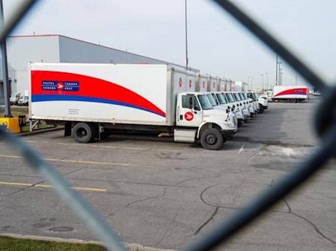 Idle Canada Post trucks sit in the parking lot of the Saint-Laurent sorting facility in Montreal as rotating strikes hit the area on Thursday November 15, 2018. THE CANADIAN PRESS/Ryan Remiorz