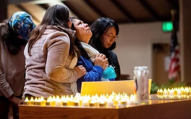 Lidia Steineman, who lost her home in the Camp Fire, prays during a vigil for fire victims on Sunday, Nov. 18, 2018, in Chico, Calif. (AP Photo/Noah Berger, Pool)