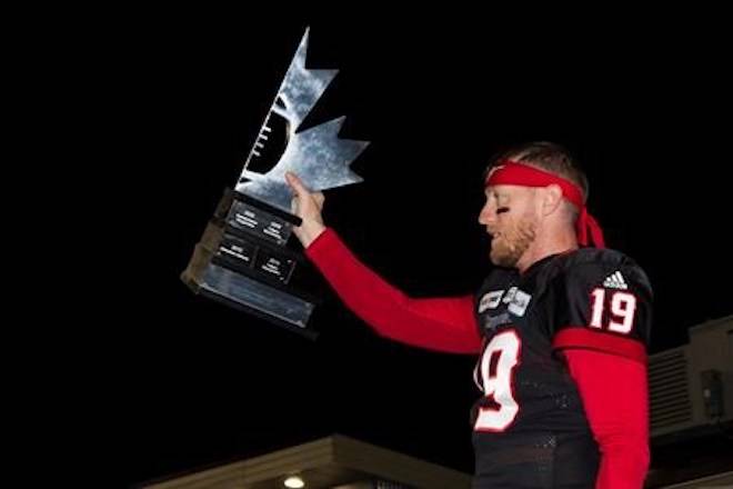 Calgary Stampeders’ quarterback Bo Levi Mitchell hoists the West Division Trophy after they defeated the Winnipeg Blue Bombers during the CFL West Final in Calgary, Sunday, Nov. 18, 2018.THE CANADIAN PRESS/Todd Korol
