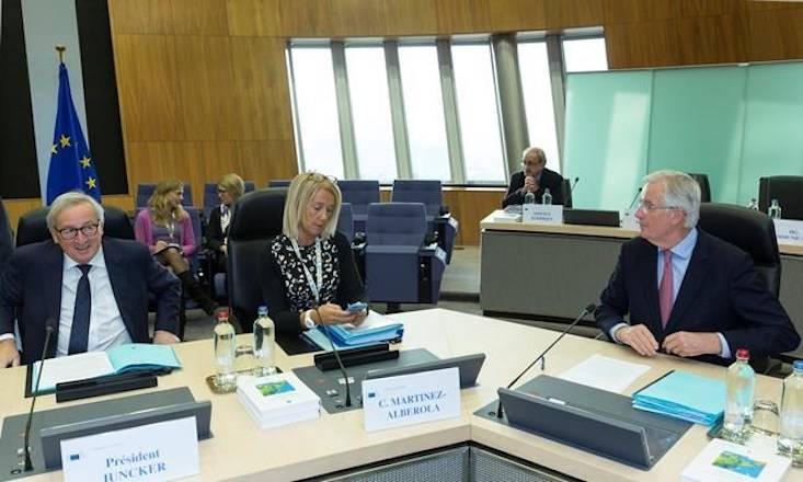 European Commission President Jean-Claude Juncker, left, and European Union chief Brexit negotiator Michel Barnier, right, attend a meeting of the College of Commissioners at EU headquarters in Brussels, Thursday, Nov. 22, 2018. (AP Photo/Thierry Monasse)