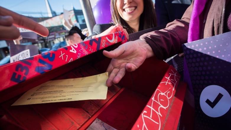 A person mails their electoral reform referendum ballot after a rally in Vancouver on Sunday, Nov. 18, 2018. THE CANADIAN PRESS/Darryl Dyck