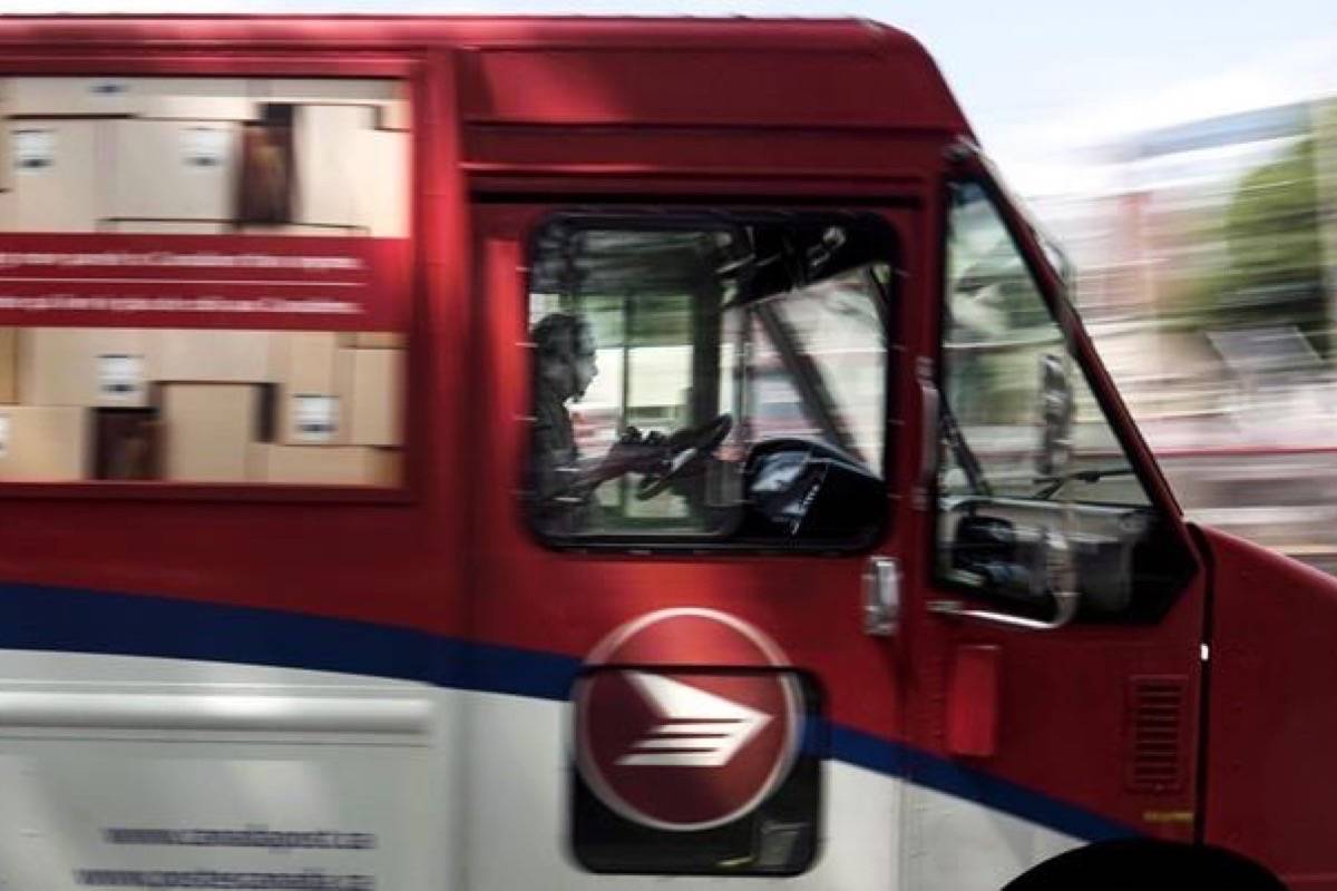 A Canada Post employee drives a mail truck through downtown Halifax on Wednesday, July 6, 2016. (Darren Calabrese/The Canadian Press)