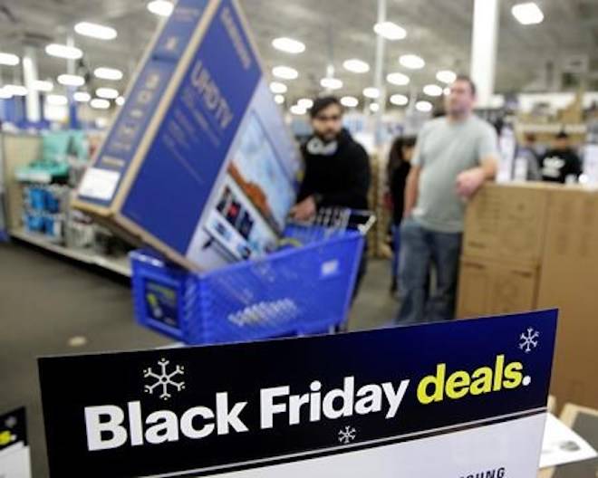 People wait in line to buy televisions as they shop during an early Black Friday sale at a Best Buy store on Thanksgiving Day Thursday, Nov. 22, 2018, in Overland Park, Kan. (AP Photo/Charlie Riedel)