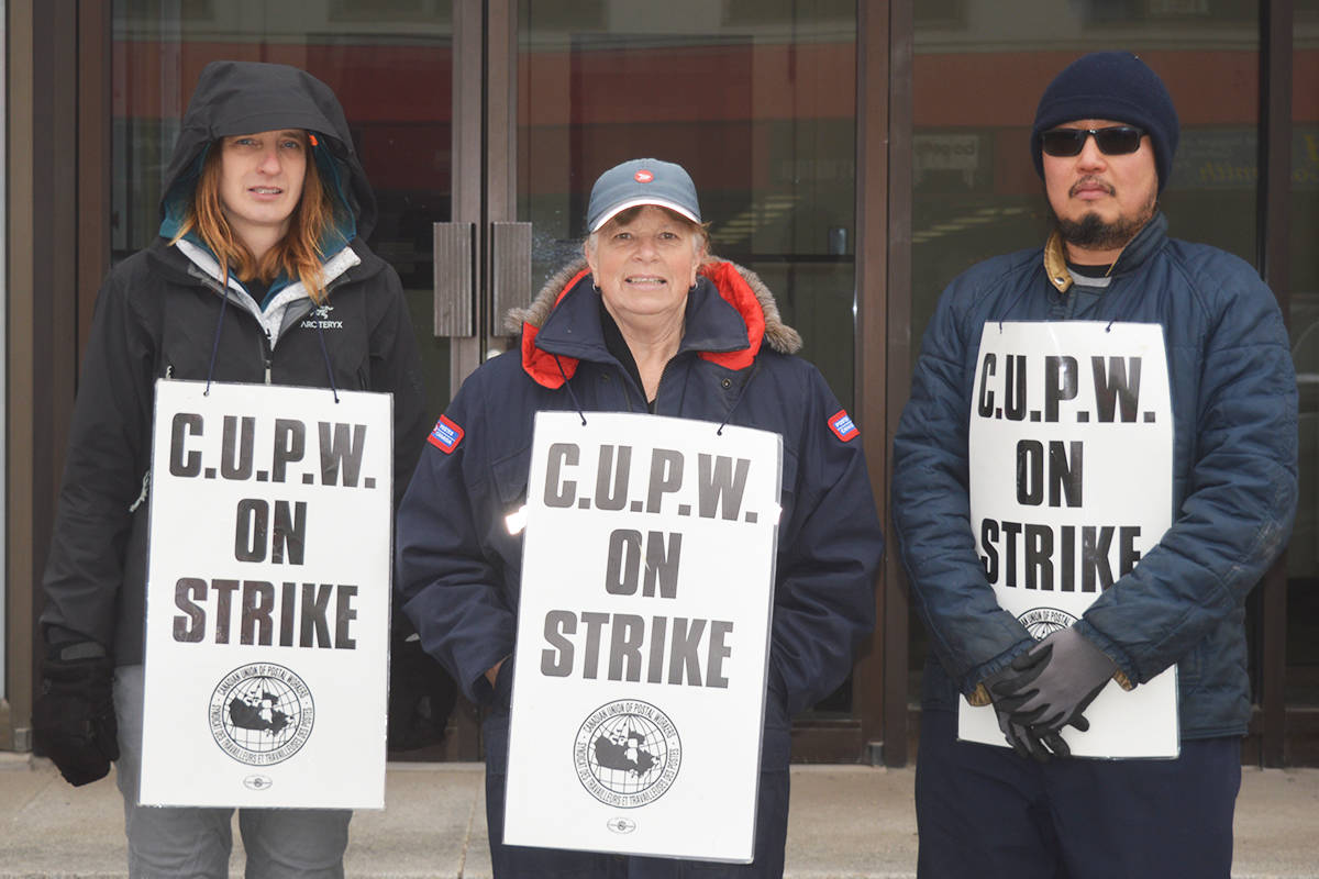 Canada Post employees picket in front of their office in Quesnel. (Black Press Media files)