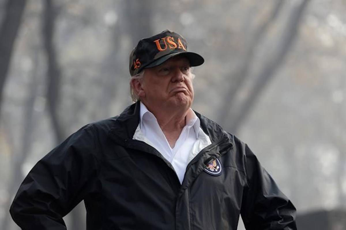 FILE - In this Nov. 17, 2018 file photo U.S. President Donald Trump visits a neighborhood impacted by the wildfires in Paradise, Calif. Forest fires from California to Greece, droughts in Germany and Australia, tropical cyclones Mangkhut in the Pacific and Michael in the Atlantic: scientists say this year’s extreme weather offers a glimpse of disasters to come if global warming continues unabated. (AP Photo/Evan Vucci, file)