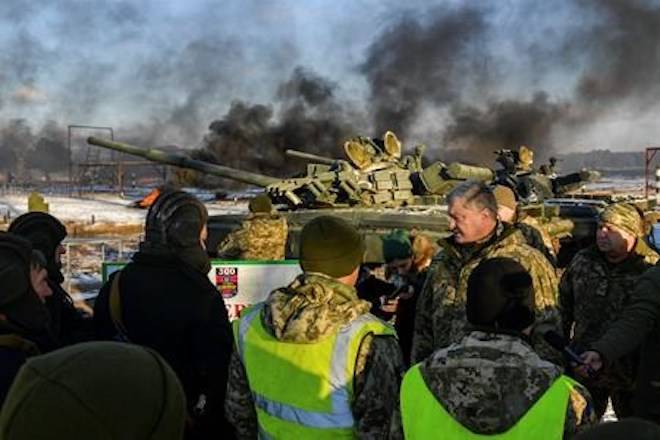 Ukrainian President Petro Poroshenko, second from right, speak with soldiers during a military training at a military base in Chernihiv region, Ukraine, Wednesday, Nov, 28, 2018. Russia and Ukraine traded blame after Russian border guards on Sunday opened fire on three Ukrainian navy vessels and eventually seized them and their crews. The incident put the two countries on war footing and raised international concern. (Mykola Lazarenko, Presidential Press Service via AP)