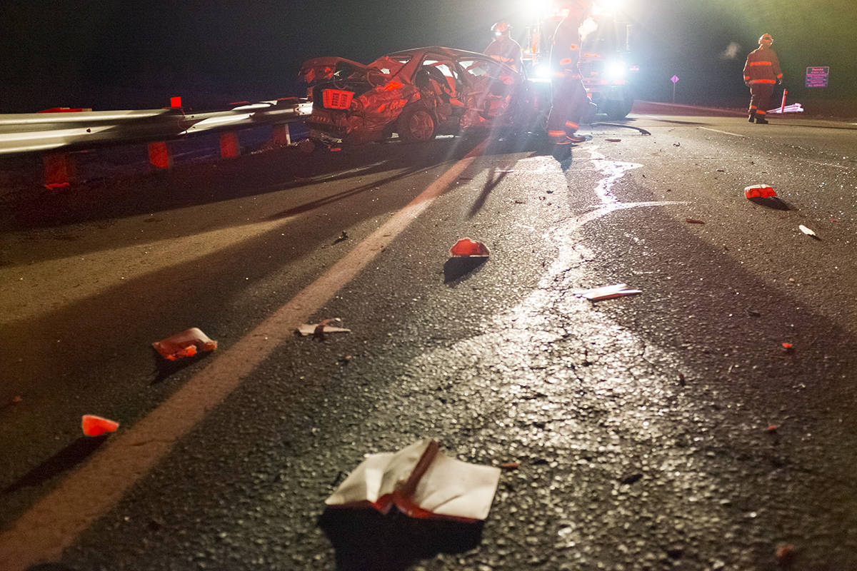 Members of the Ponoka County East District Fire Department clean up a collision scene just after midnight on Thursday. The incident involved a 22-year-old man who died as a result.                                Photo by Jeffrey Heyden-Kaye