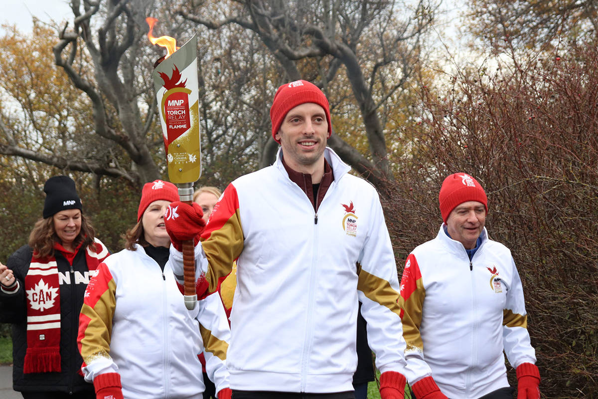 Canadian Olympian and Canada Games alumni, swimmer Ryan Cochrane, leads an MNP Canada Games Torch Relay group.
