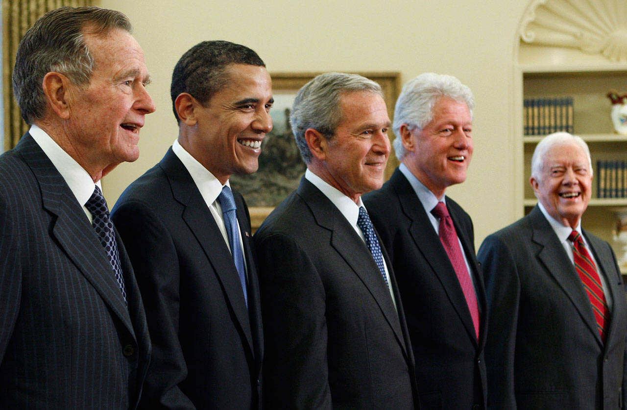 In this Jan. 7, 2009, file photo, President George W. Bush, center, poses with President-elect Barack Obama, second left, and former presidents, George H.W. Bush, left, Bill Clinton, second right, and Jimmy Carter, right, in the Oval Office of the White House in Washington. Bush has died at age 94. Family spokesman Jim McGrath says Bush died shortly after 10 p.m. Friday, Nov. 30, 2018, about eight months after the death of his wife, Barbara Bush. (AP Photo/J. Scott Applewhite, File)