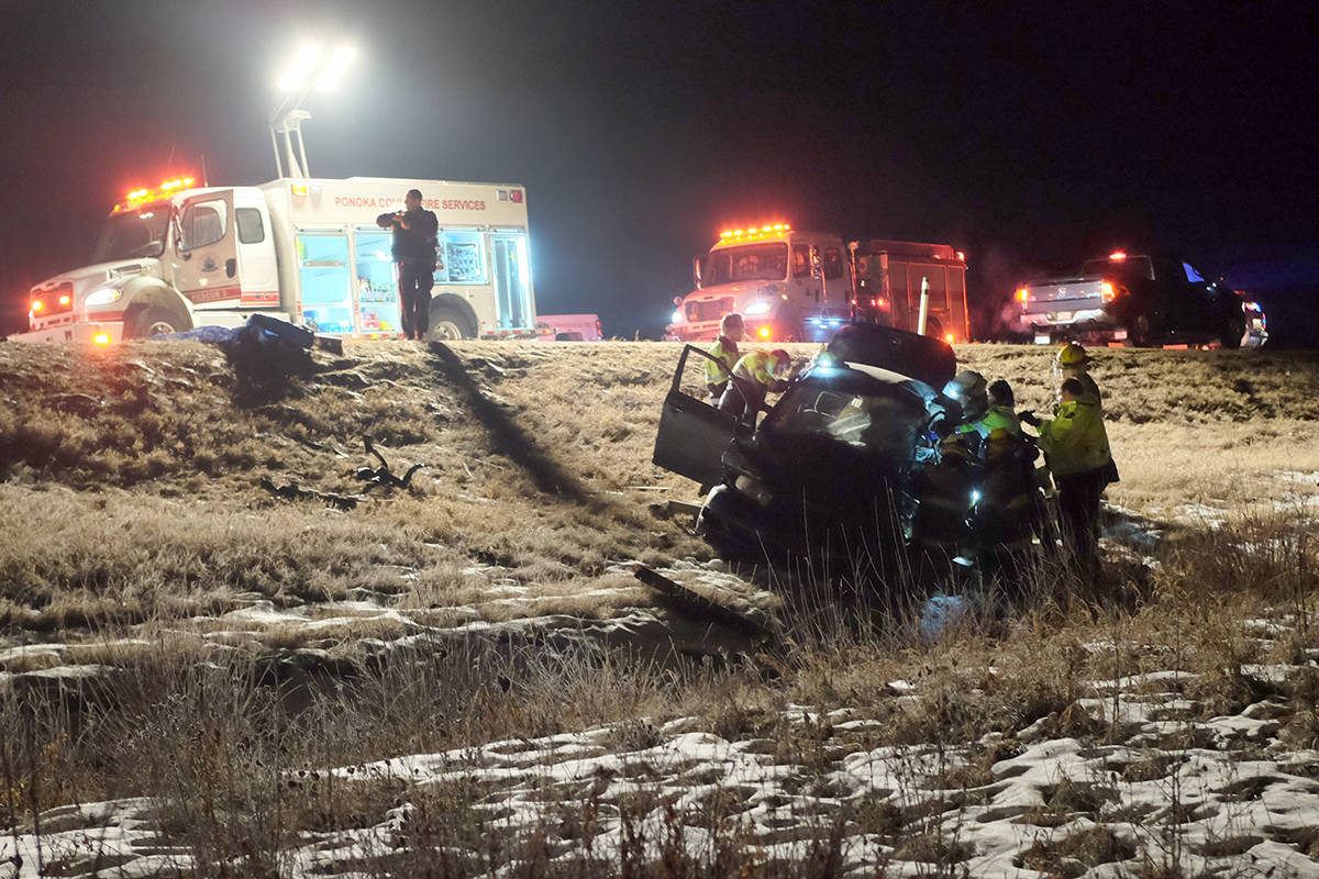 Members of the Ponoka County East District Fire Department work to extricate a driver involved in a serious collision south of Ponoka on Highway 2A Friday night. The incident was serious enough that both lanes were impassable for several hours while crews investigated. It’s not known the severity of the injuries from the incident.                                Photo by Jeffrey Heyden-Kaye