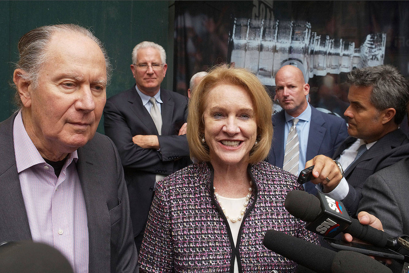 Seattle Hockey Partners David Bonderman, left, and Seattle Mayor Jenny Durkan talk to the media as they leave a meeting at National Hockey League headquarters, Tuesday, Oct. 2, 2018, in New York. Members of Seattle’s potential ownership group and Mayor Durkan presented their case to the Board of Governors’ executive committee at the league office. If the executive committee moves the process forward, the board could vote as soon as December to award the NHL’s 32nd franchise to Seattle. (AP Photo/Mark Lennihan)