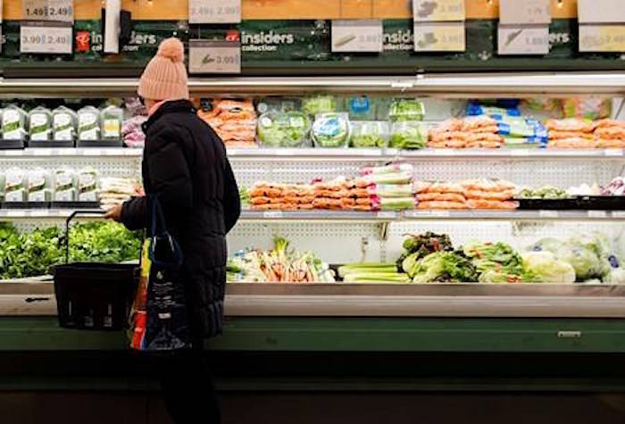 A women overlooks produce in a grocery store in Toronto on Friday, Nov. 30, 2018. An annual report estimates the average Canadian family will pay about $400 more for groceries and roughly $150 more for dining out next year. THE CANADIAN PRESS/Nathan Denette