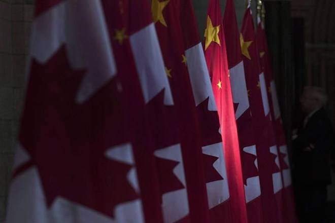 A Chinese flag is illuminated by sunshine in the Hall of Honour on Parliament Hill in Ottawa, Thursday September 22, 2016. THE CANADIAN PRESS/Adrian Wyld