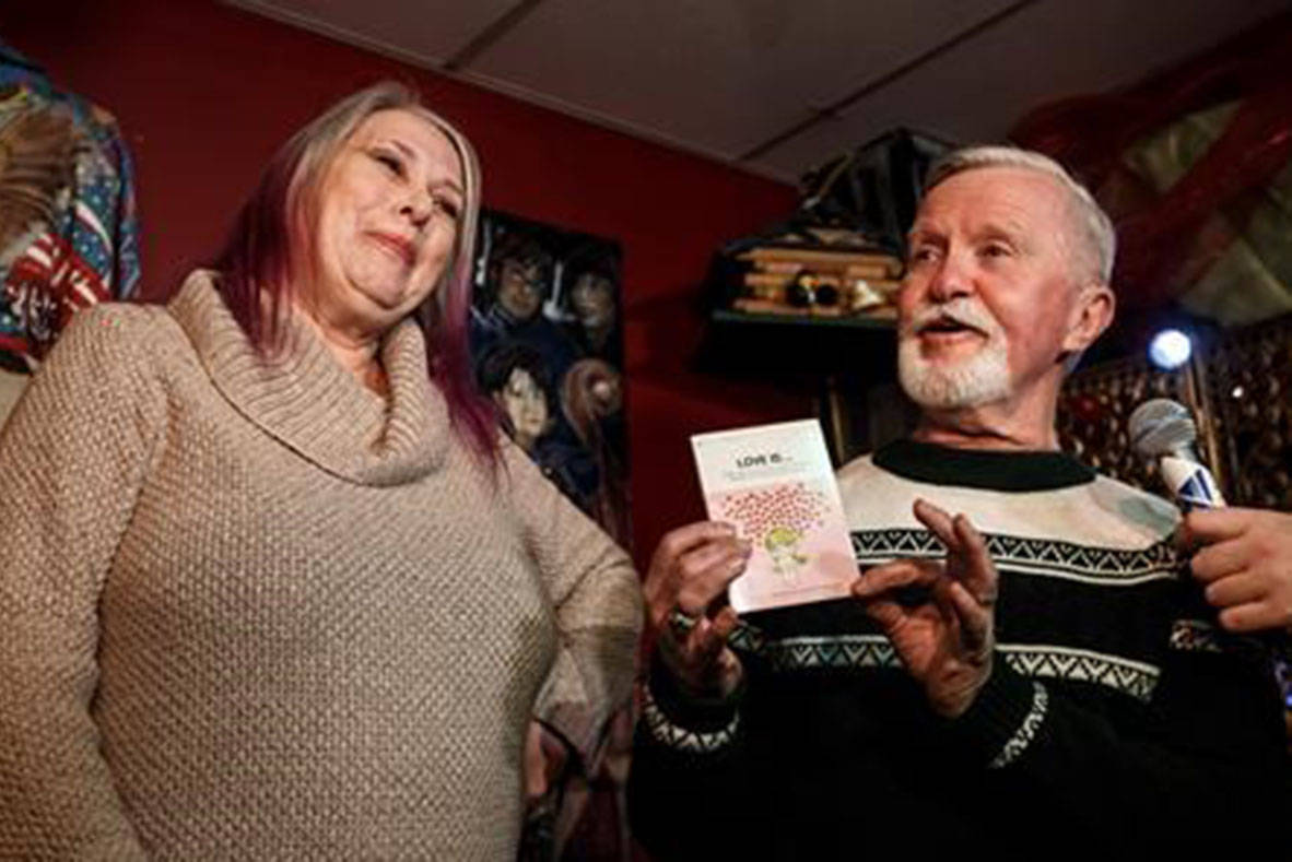 Adrian Pearce and his ex high school girl friend Vicki Allen open the 47 year old gift, a book called Love Is, which she gave him when they broke up in 1971, in St. Albert, Alta., on Thursday, Dec. 6, 2018. 47 years ago Adrian Pearce was given the gift the same day Vicki Allen broke up with him and he never opened it until now. THE CANADIAN PRESS/Jason Franson