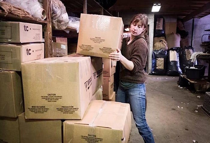 Custom Woollen Mills manager Maddy Purves-Smith, who is struggling with shipping options during the company’s busiest time of year, packages an order at the facility near Carstairs, Alta., Thursday, Dec. 6, 2018.THE CANADIAN PRESS/Jeff McIntosh
