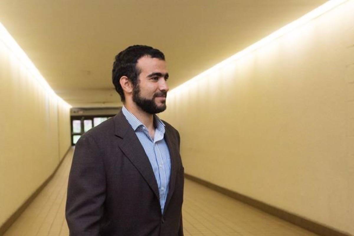 Omar Khadr leaves court after a judge ruled to relax bail conditions in Edmonton on Friday, Sept. 18, 2015. Former Guantanamo Bay detainee Omar Khadr wants to change some of the conditions of his bail, asking for a Canadian passport to travel to Saudi Arabia and requesting phone contact with his controversial sister. (Amber Bracken/The Canadian Press)