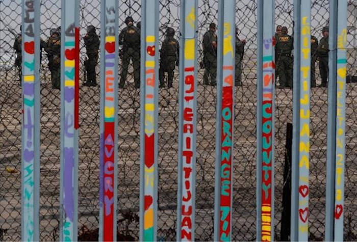 U.S. Border Patrol agents stand guard on the other side of the border in San Diego as they prepare for the arrival of hundreds of pro-migration protestors, seen through the border fence from Tijuana, Mexico, Monday, Dec. 10, 2018.(AP Photo/Rebecca Blackwell)