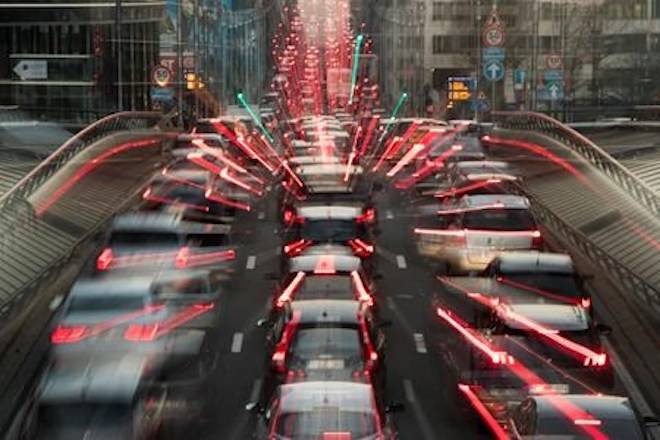 In this slow-shutter zoom effect photo, commuters backed up in traffic during the morning rush hour Wednesday, Dec. 12, 2018, in Brussels, a city that regularly experiences pollution alert warnings. (AP Photo/Francisco Seco)