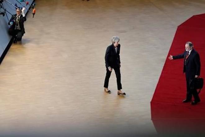 Britain’s Ambassador to the EU Sir Tim Barrow, right, gestures to British Prime Minister Theresa May after she spoke with the media at an EU summit in Brussels, Thursday, Dec. 13, 2018. (AP Photo/Alastair Grant)