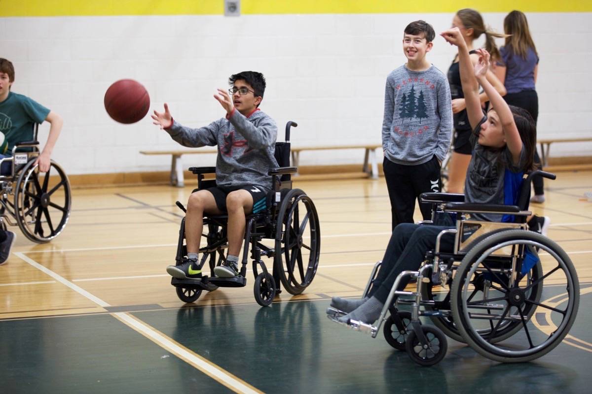 Westpark Middle School Grade 8 students Daksh Sethi, left, Avery Bettesworth and Nathan Randall play wheelchair basketball as part of Inclusive Schools Week this week. Robin Grant/Red Deer Express