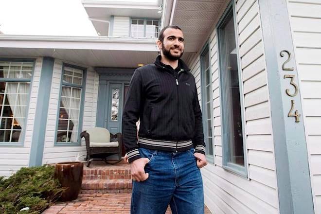 Omar Khadr walks out the front door of his lawyer Dennis Edney’s home to speak the media in Edmonton, Thursday, May 7, 2015. THE CANADIAN PRESS/Nathan Denette