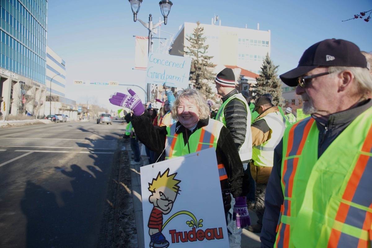 More than 100 people took to the streets outside City Hall Saturday morning to protest Prime Minister Justin Trudeau’s policies on oil pipelines and immigration. Robin Grant/Red Deer Express