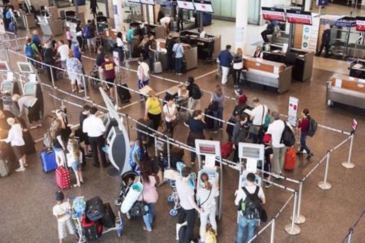 Passengers wait to check in at Trudeau Airport in Montreal on July 19, 2017. (THE CANADIAN PRESS/Ryan Remiorz)