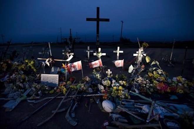 A memorial made of hockey sticks, crosses and Canadian flags is seen at the crash site of the Humboldt Broncos hockey team near Tisdale, Sask., Friday, August, 24, 2018. THE CANADIAN PRESS Jonathan Hayward