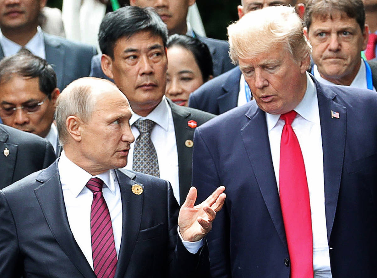 FILE - In this Nov. 11, 2017, file photo, U.S. President Donald Trump, right, and Russia’s President Vladimir Putin talk during the family photo session at the APEC Summit in Danang. (Mikhail Klimentyev, Sputnik, Kremlin Pool Photo via AP, file)