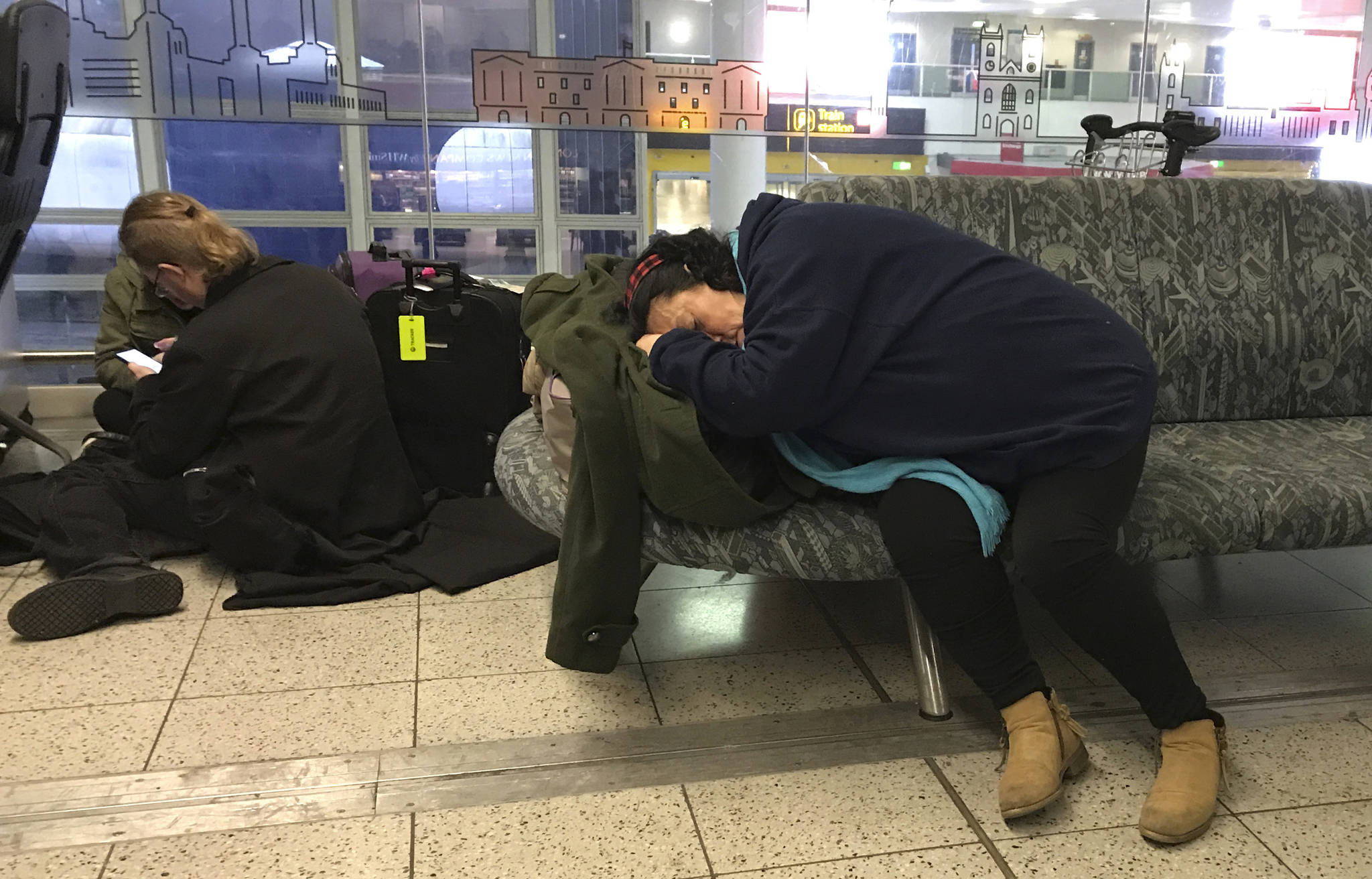 Passengers wait at Gatwick Airport in England, Friday, Dec. 21, 2018. Flights resumed at London’s Gatwick Airport on Friday morning after drones sparked the shutdown of the airfield for more than 24 hours, leaving tens of thousands of passengers stranded or delayed during the busy holiday season. (AP Photo/Kirsty Wigglesworth)