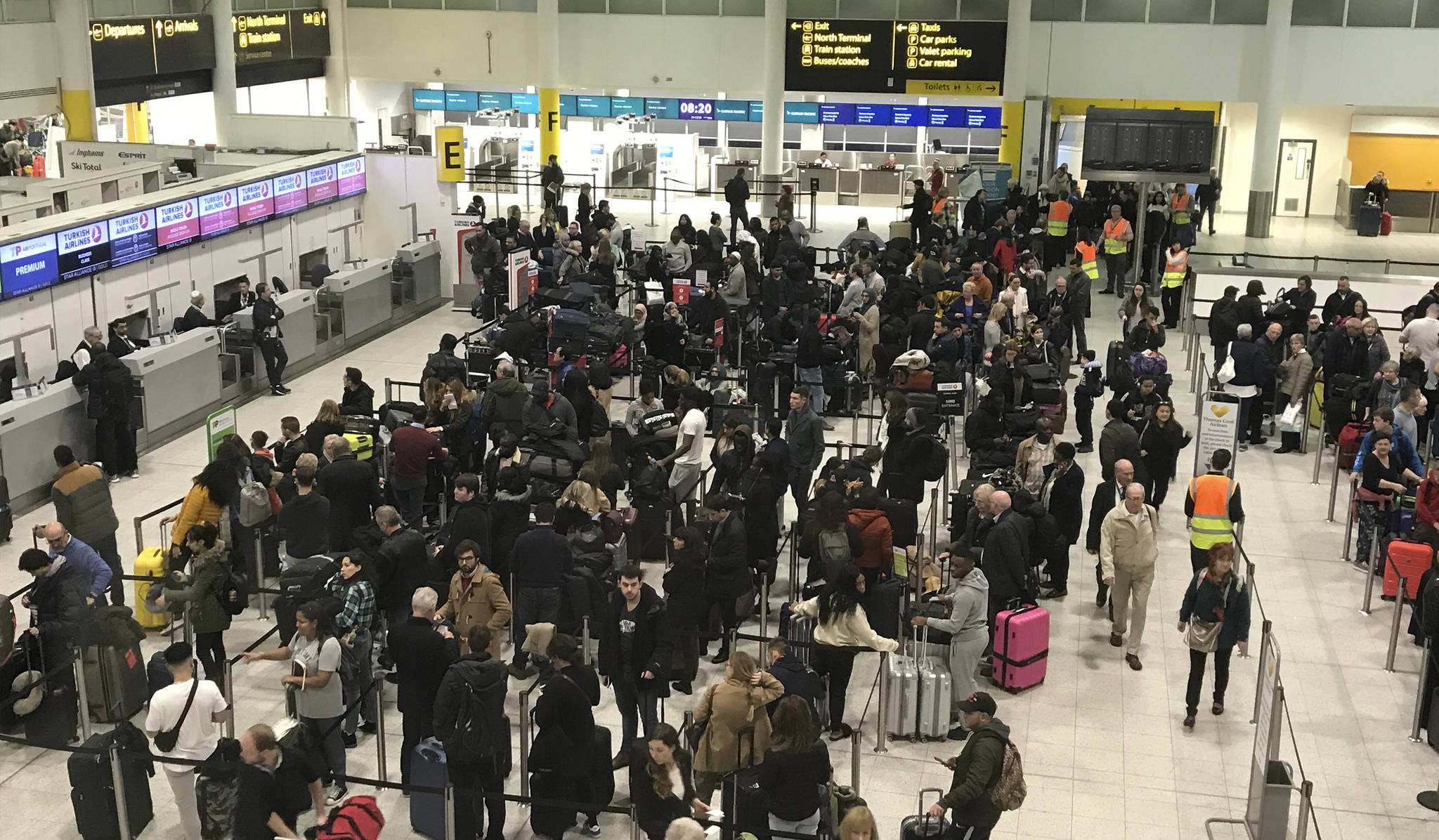 Passengers wait to check in at Gatwick Airport in England, Friday, Dec. 21, 2018. Flights resumed at London’s Gatwick Airport on Friday morning after drones sparked the shutdown of the airfield for more than 24 hours, leaving tens of thousands of passengers stranded or delayed during the busy holiday season. (AP Photo/Kirsty Wigglesworth)
