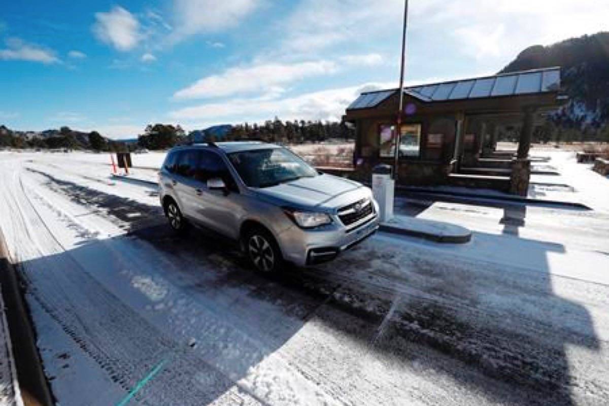 Motorists glide through the unattended toll booths at Rocky Mountain National Park Saturday, Dec. 22, 2018, in Estes Park, Colo. A partial federal shutdown has been put in motion because of gridlock in Congress over funding for President Donald Trump’s Mexican border wall. The gridlock blocks money for nine of 15 Cabinet-level departments and dozens of agencies including the departments of Homeland Security, Transportation, Interior, Agriculture, State and Justice. (AP Photo/David Zalubowski)