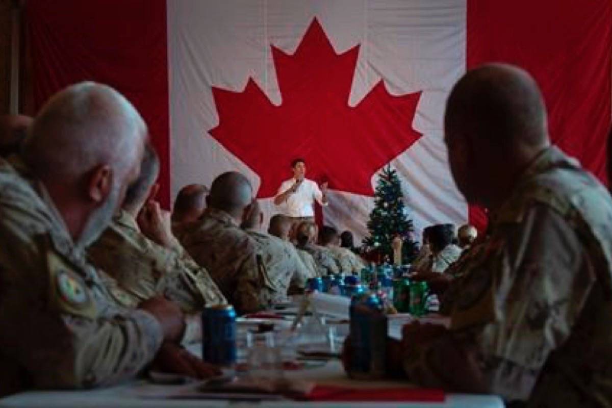 Canadian Armed Forces personnel serving on the United Nations Multidimensional Integrated Stabilization Mission listen as Prime Minister Justin Trudeau speaks to them following a turkey dinner in Gao, Mali, Saturday December 22, 2018. (Adrian Wyld/The Canadian Press)